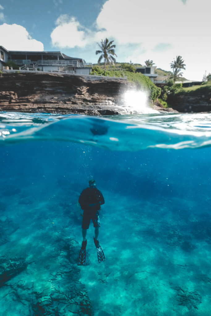 diver lurks beneath China Walls dive site scubadive site on Oahu